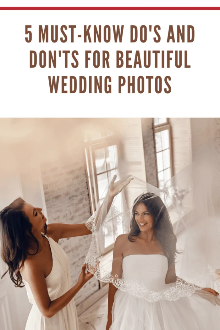 bride with maid of honor holding veil