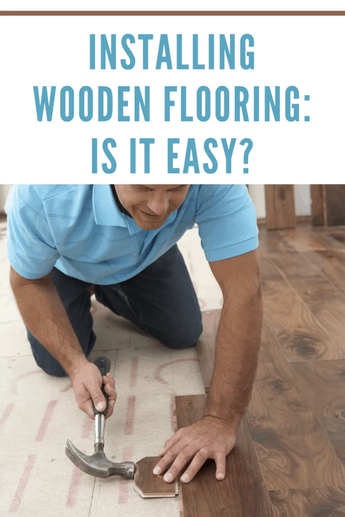 man installing wooden flooring