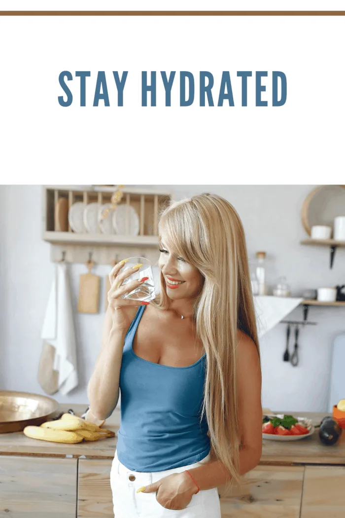 woman in kitchen drinking water