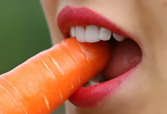 girl eating a carrot