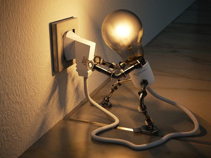lightbulb light that looks like a man plugging a plug into an outlet