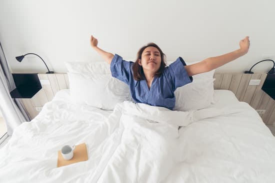 Asian girl Stretching the body after waking up in the morning. Make it brighter and with day activities. The concept of adequate sleep. Good sleep