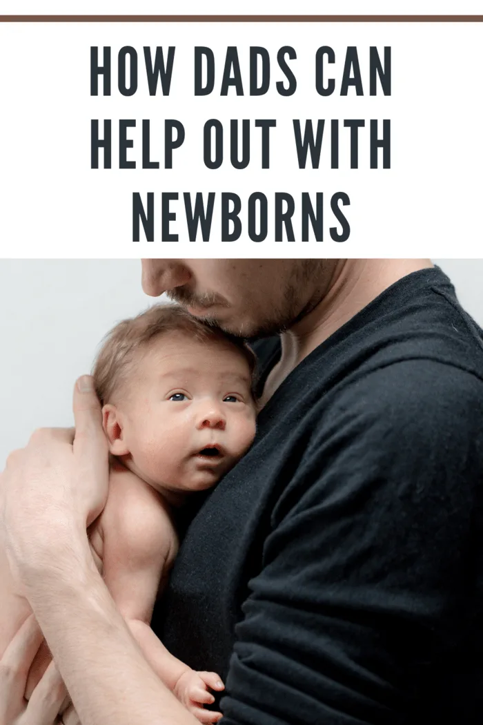 dad in black shirt with newborn resting on chest.