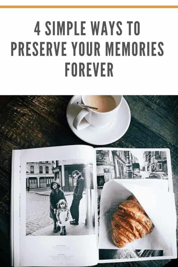 photo book with black and white photos open with croissont in wrapper resting on top of pages and coffee at top of book