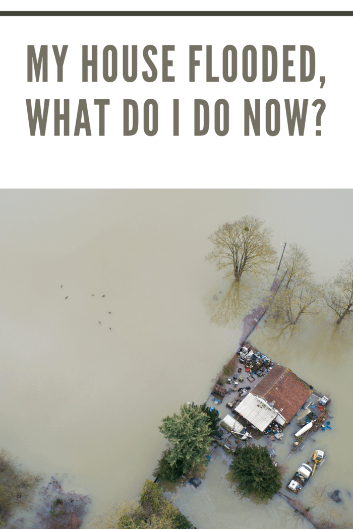 aerial view of flooding with house on lot with trees 