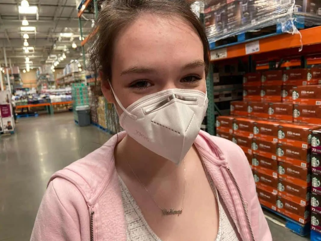young woman wearing KN95 face mask at Costco