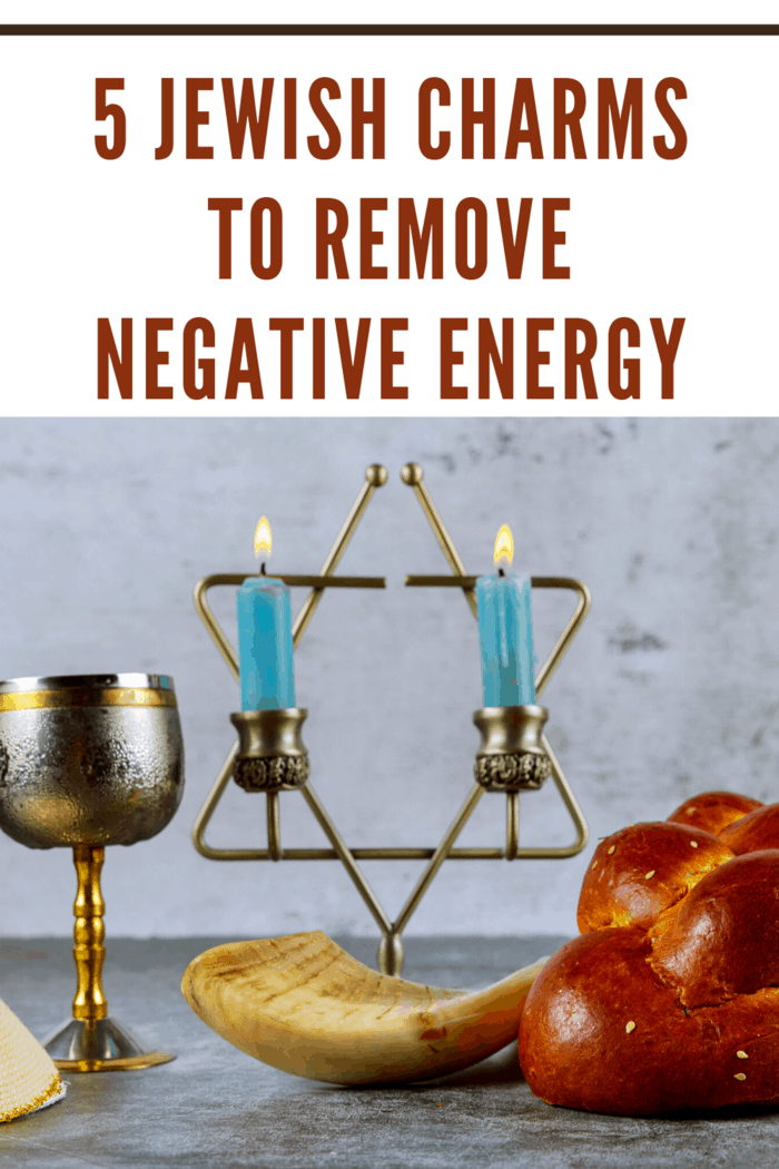 shabbat candles on table with challah bread and wind cup