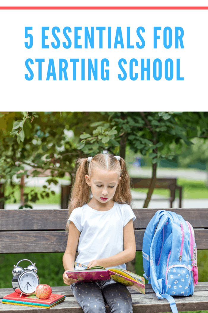 girl with pig tails sitting on bend with backpack