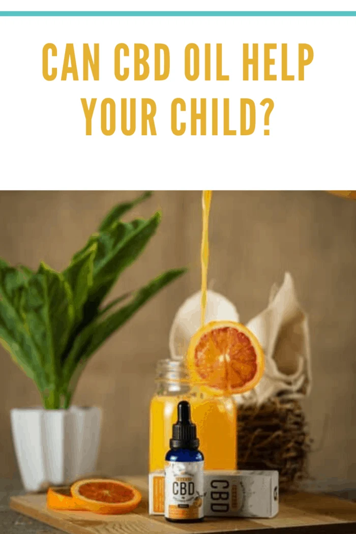 CBD oil for kids on table with orange juide being poured in the background