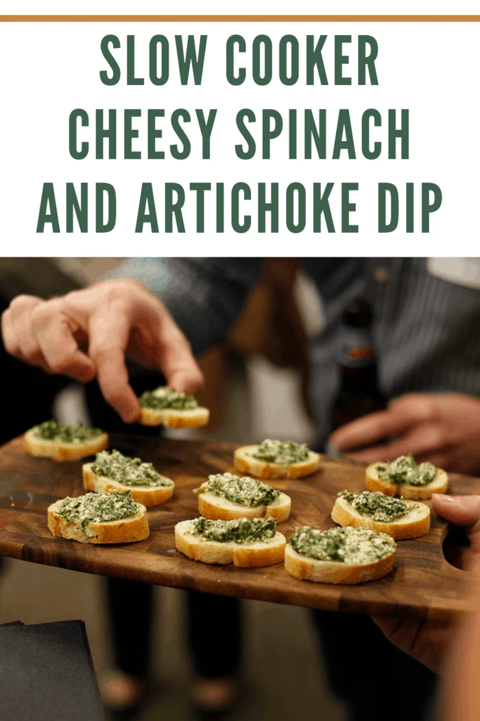 Serving appetizers with slow cooker cheesy spinach and artichoke dip on toasted bread slices at a gathering