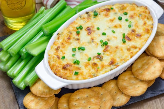 Baked crab dip, served with celery sticks and crackers