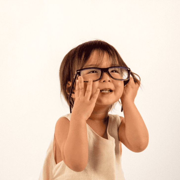 little girl with adult glasses on