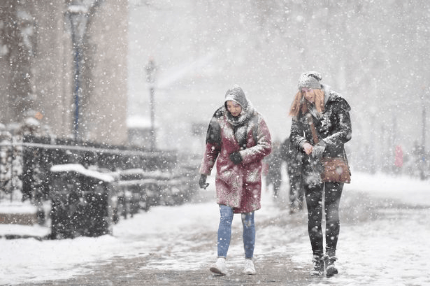 women walking in snow storm