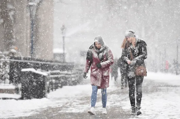 women walking in snow storm