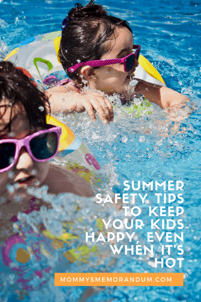 two little girls in pool with sunglasses and arm floats practicing summer safety