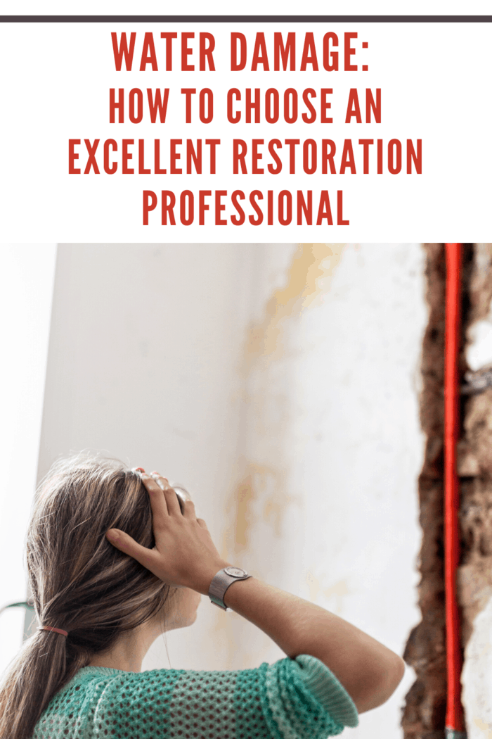 woman looking at wall after water damage