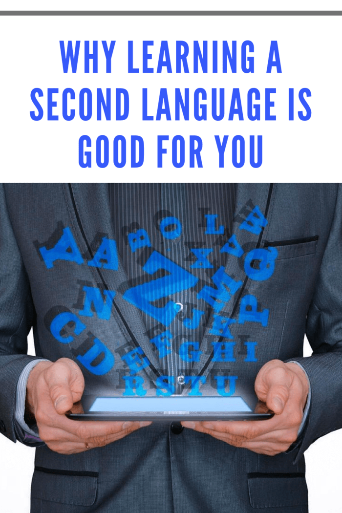 man in suit holding ebook with letters postitioned above ebook to represent learning a second language