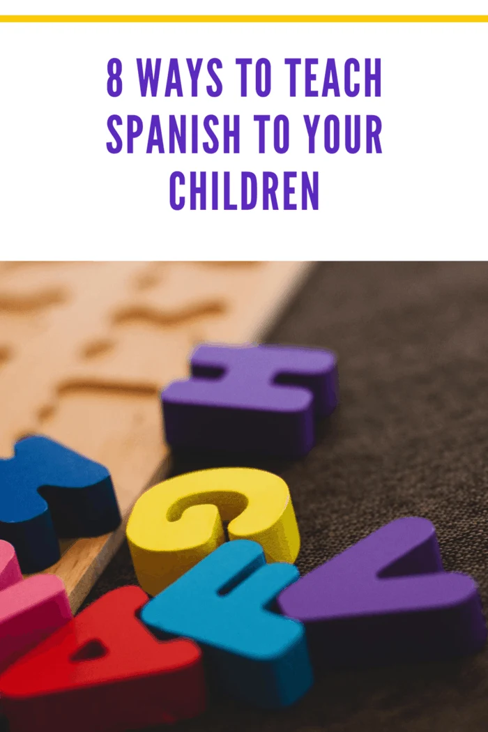 colorful alphabet letters made of wood scattered and ready for puzzle as one of the ways to teach your child spanish