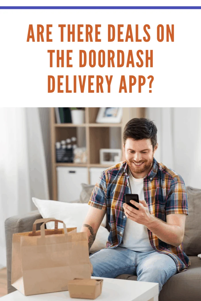 technology, consumption and people concept - smiling man using smartphone with dealdash delivery app for food delivery at home