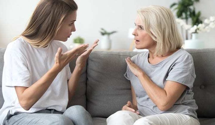 Angry young woman has disagreement with annoyed old mother in law, grown daughter arguing fighting quarreling with annoying mom, different age generations bad relations family conflict concept
