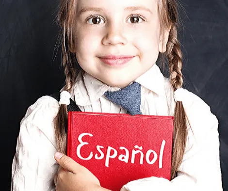 Kid learning spanish. Little girl with spanish book