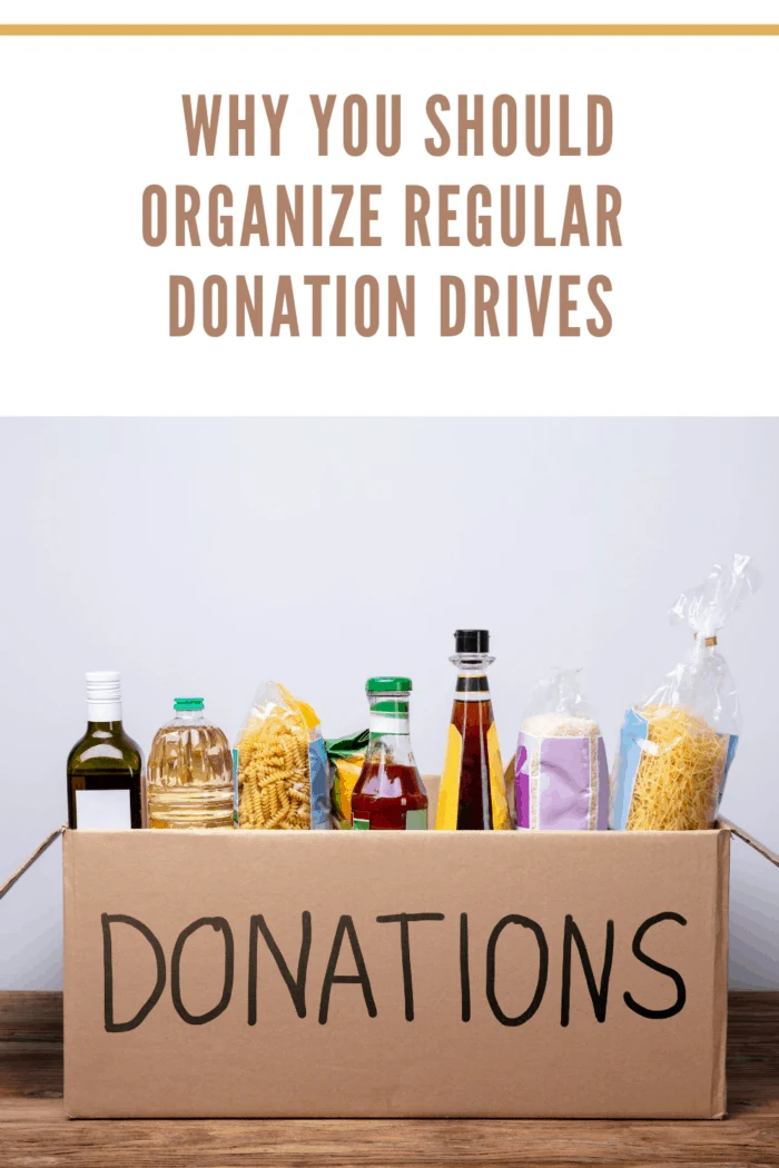 Close-up Of A Donation Box With Various Food Items On Wooden Desk