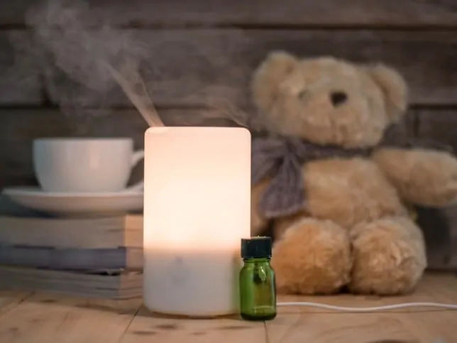 Ultrasonic humidifier on a wooden table, aroma maker in a home