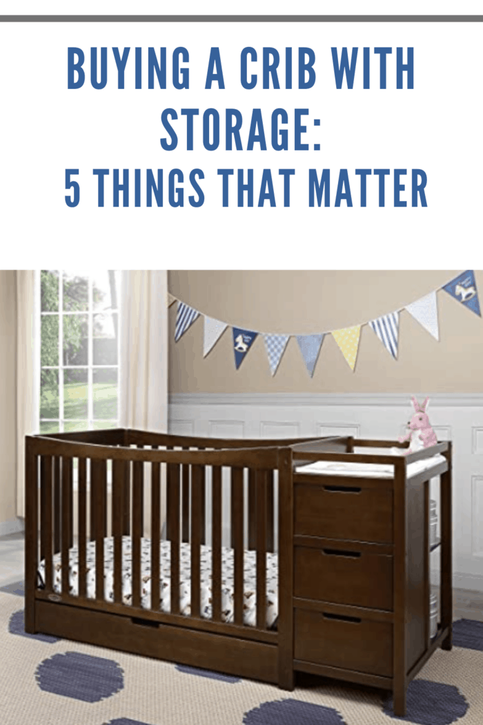 brown crib with storage in nursery in blues and greys