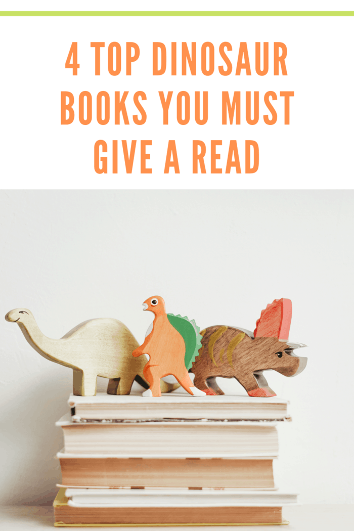 wooden dinosaurs on top of four dinosaur books you must read