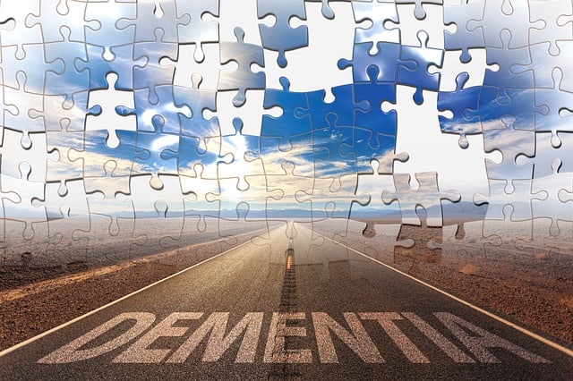 road leading into horizon with picture as a jigsaw puzzle and the word dementia on the bottom depciting problem solving and puzzle fun for the elderly with dementia