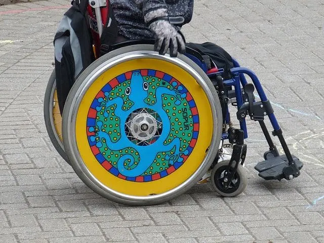 child's wheelchair with chameleon wheels after child brain injury
