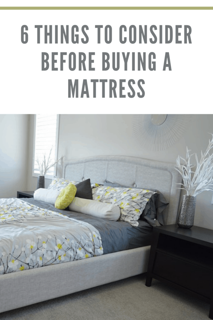 best mattress under gray bedspread with yellow accents