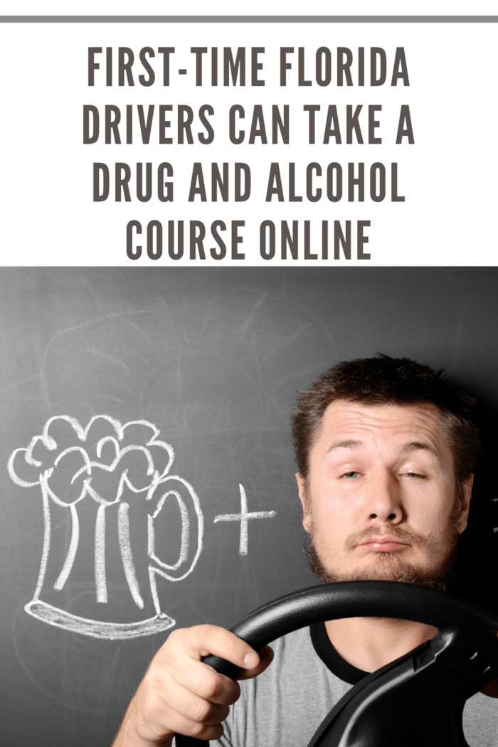 Man against the chalkboard holding a steering wheel, drawing of a beer mug and handcuffs representing florida drivers drug and alcohol course