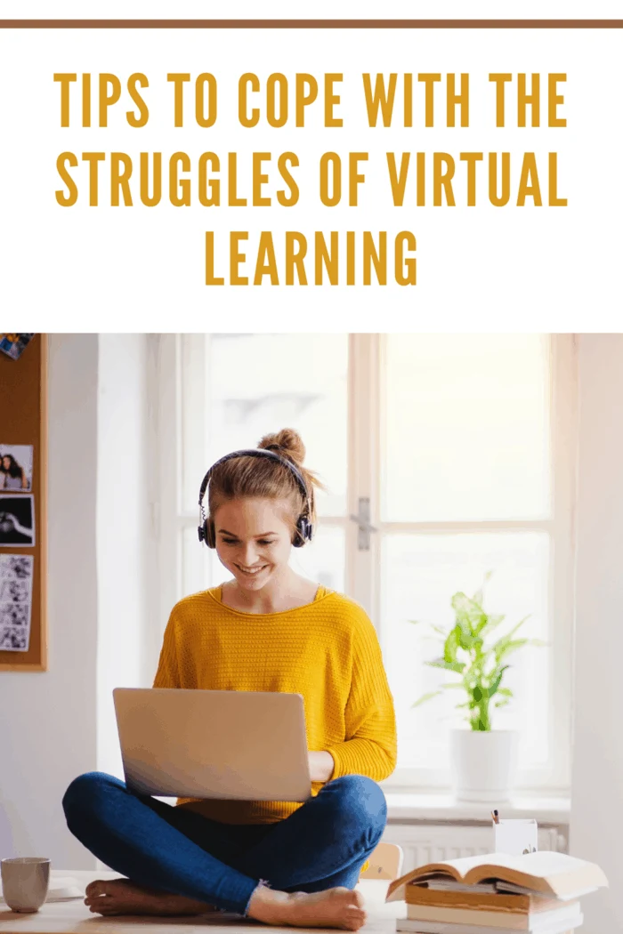 teen in yellow shirt with headphones sitting on windowsill doing online studies