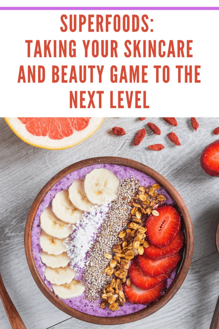 Acai smoothie bowl with superfoods. Smoothy bowl topped with banana, chia seed, coconut, strawberry and granola representing superfoods taking your skincare and beauty game to the next level