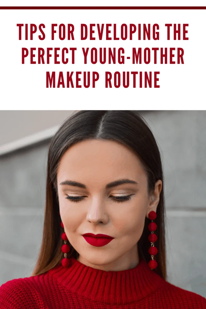 young woman perfecting young mother makeup routine with bold red lips