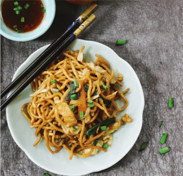 Homemade Chinese Lo Mein served with green tea overhead view