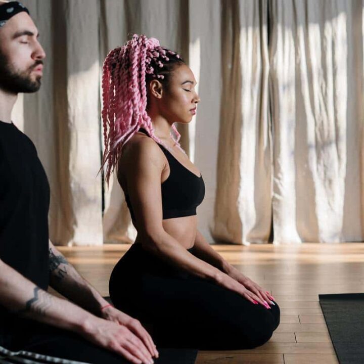 man and woman practicing relaxation and stress relief through meditation