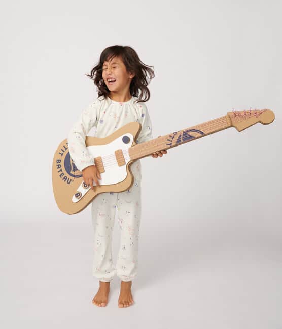 pyjamas on little girl playing giant guitar