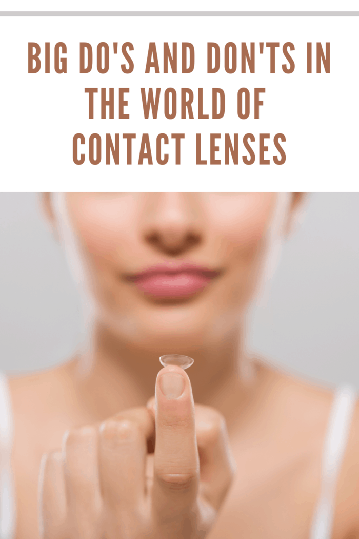 Focus on contact lens on finger of young woman. Young woman holding contact lens on finger in front of her face. Woman holding contact lens on grey background. Eyesight and eyecare concept.
