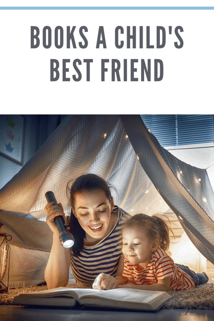 Family bedtime. Mom and child daughter are reading a book in tent. Pretty young mother and lovely girl having fun in children room.
