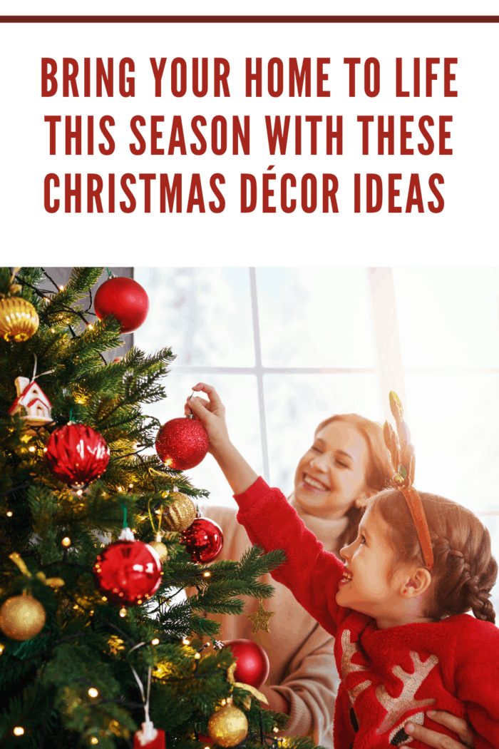 family decorating christmas tree with red and gold ornaments