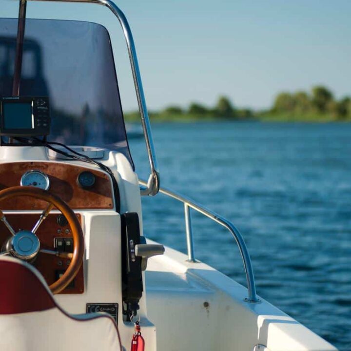 boat on water with view of steering wheel