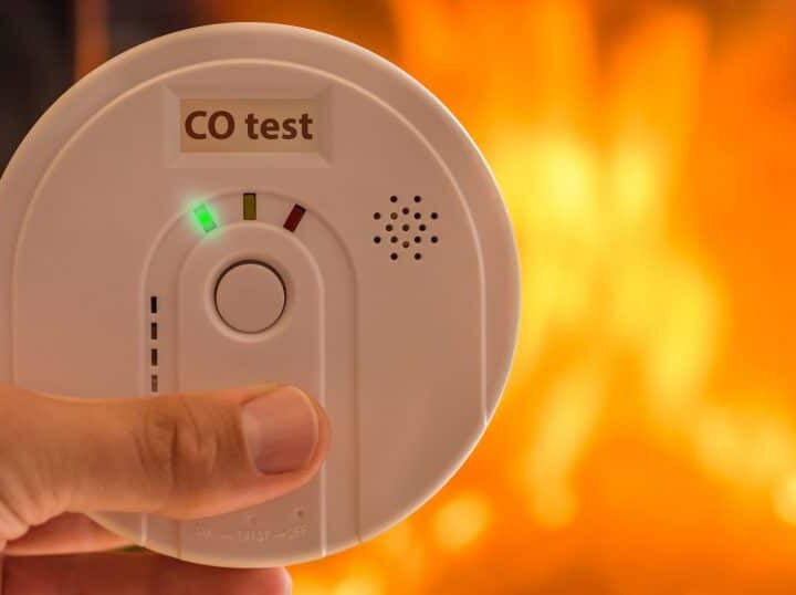 carbon monoxide poisoning alarm with fire in background