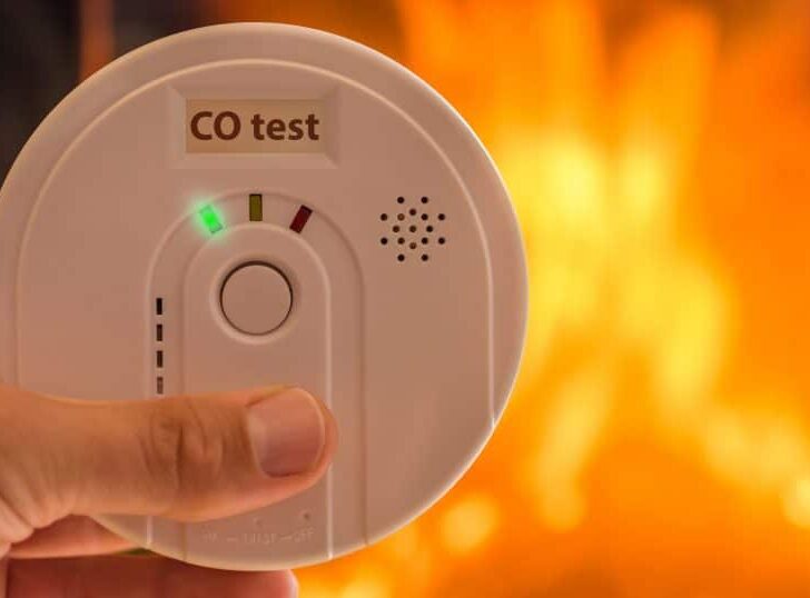 carbon monoxide poisoning alarm with fire in background