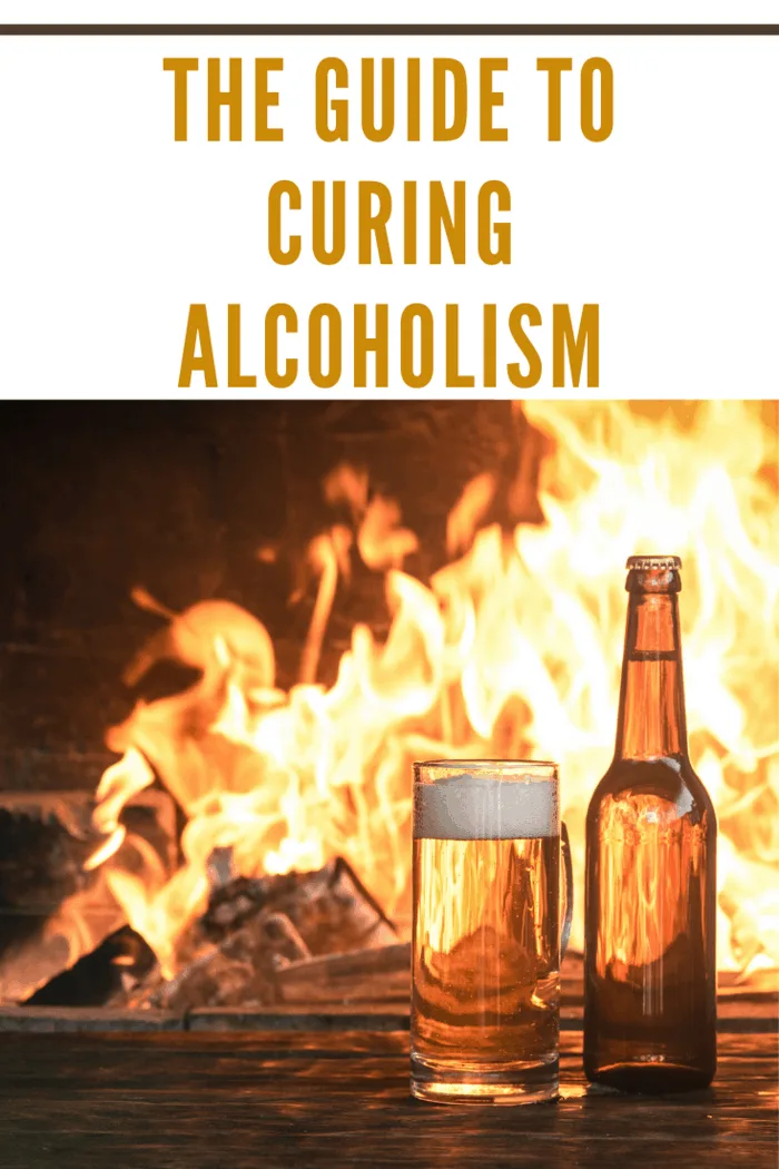 Beer in a mug and a bottle of alcohol on a wooden table on a burning fire in a fireplace background.