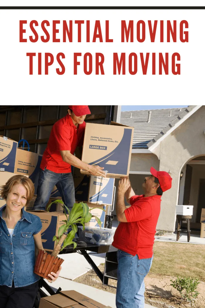 Happy couple with delivery men unloading moving boxes from truck into new house