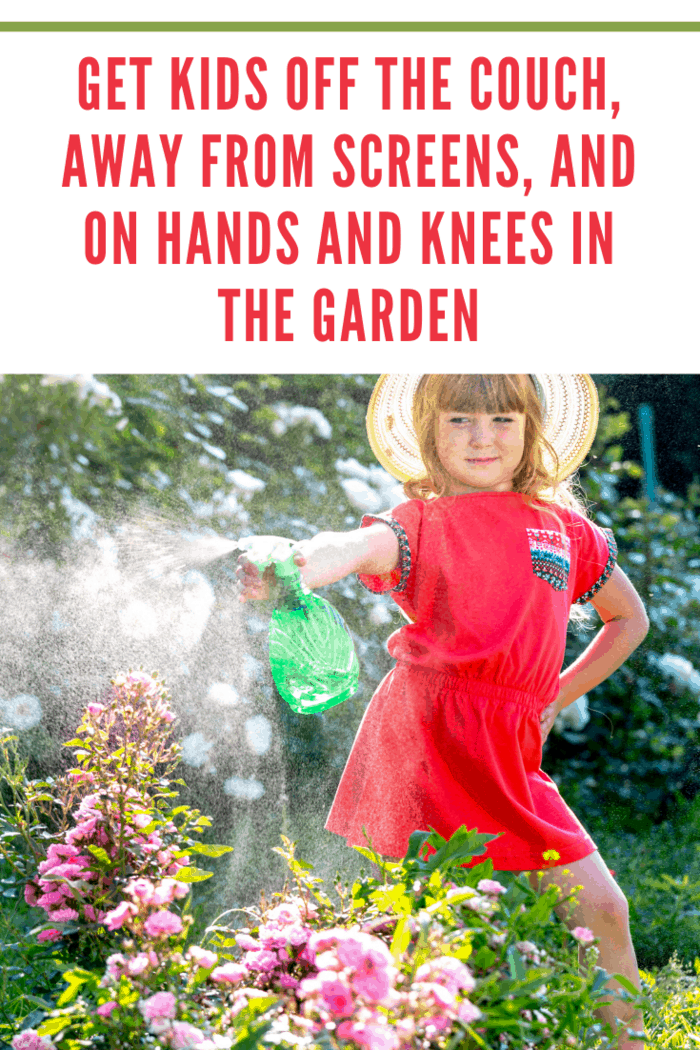 Lovely little girl caring for flowers by spraying with water in the garden