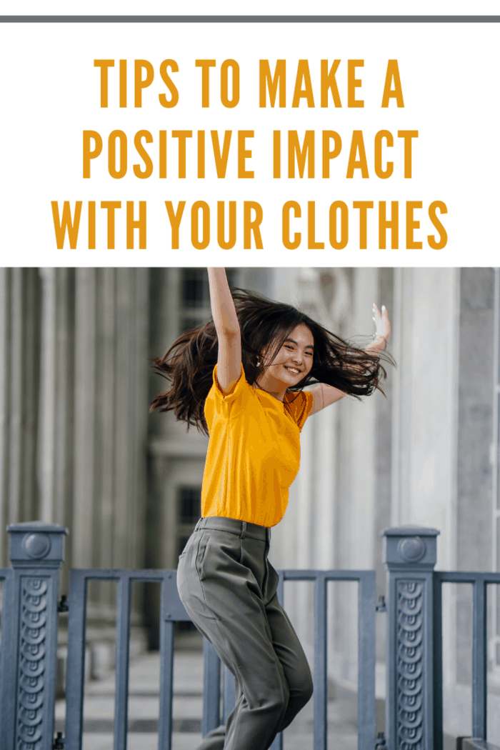 photo-of-smiling-woman-in-yellow-t-shirt-and-grey-pants-with-her-hands-raised