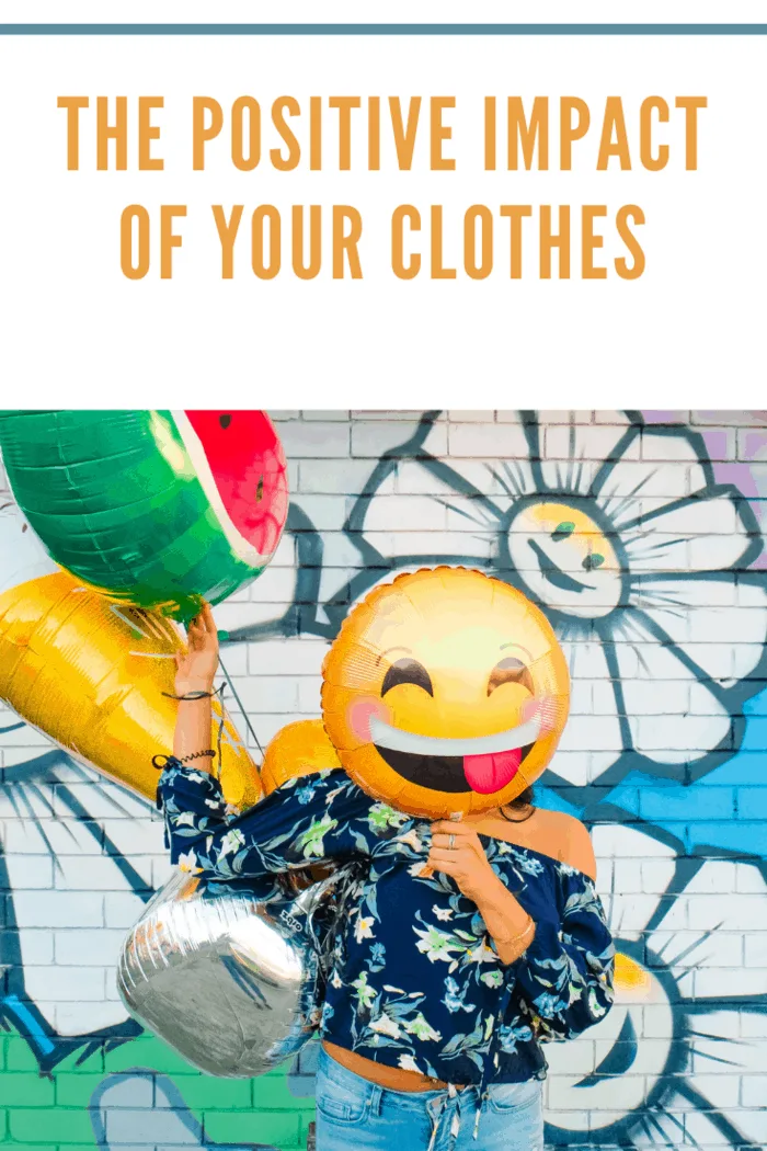 woman making a positive impact with her clothes using emoji mylar balloon for her face